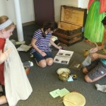 Students investigating items in an Irish immigrant's trunk.