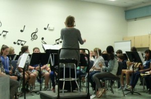 Mrs. Barry seated, talking to the 4th grade band students.