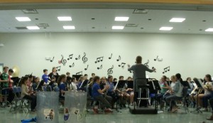 4th grade band practicing on the stage in the cafeteria.