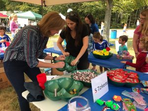 Image of the prize table with candy, small toys, tiny purses, notebooks, jump rope, stickers and tattoos.